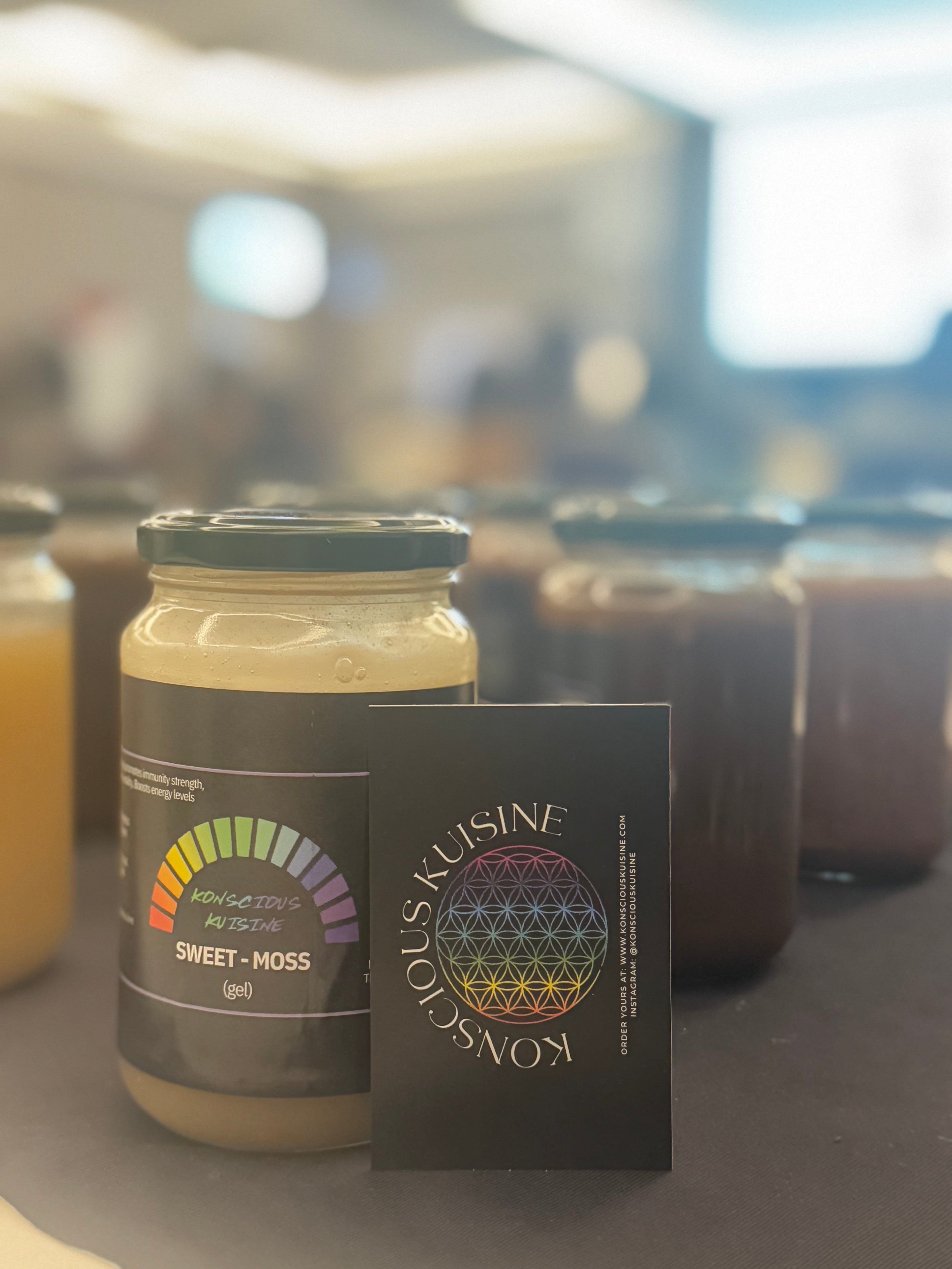 product image of a jar of sweet moss with a business card infront